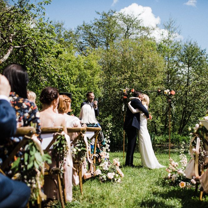Bride and Groom Embrace at Outdoor Anran Wedding Ceremony