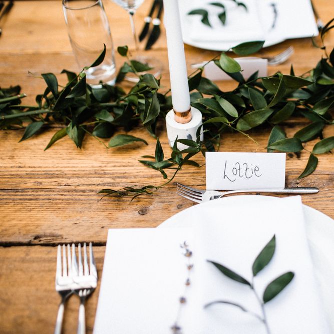 Place Setting with Greenery Runner and White Candles