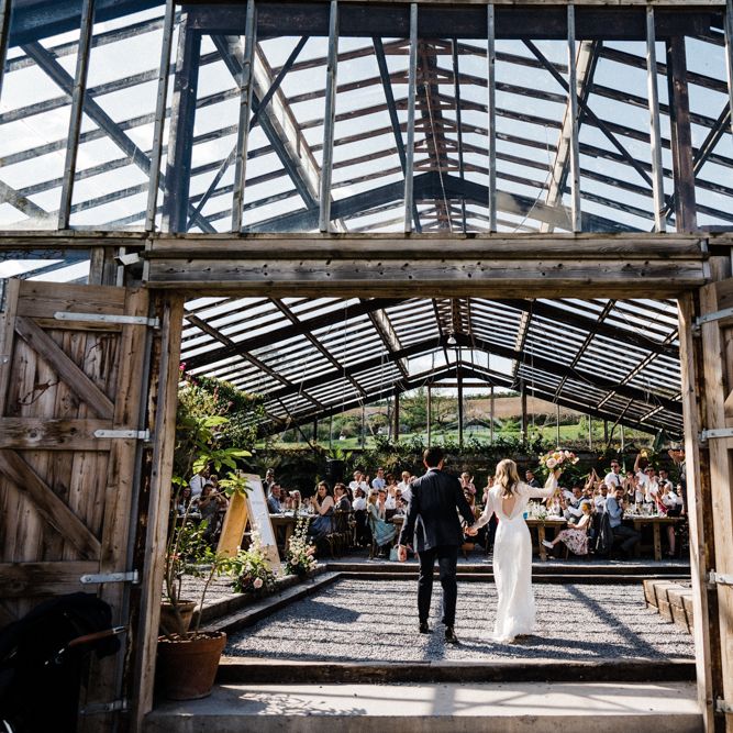Bride and Groom Entering the Glasshouse Wedding Reception at Anran