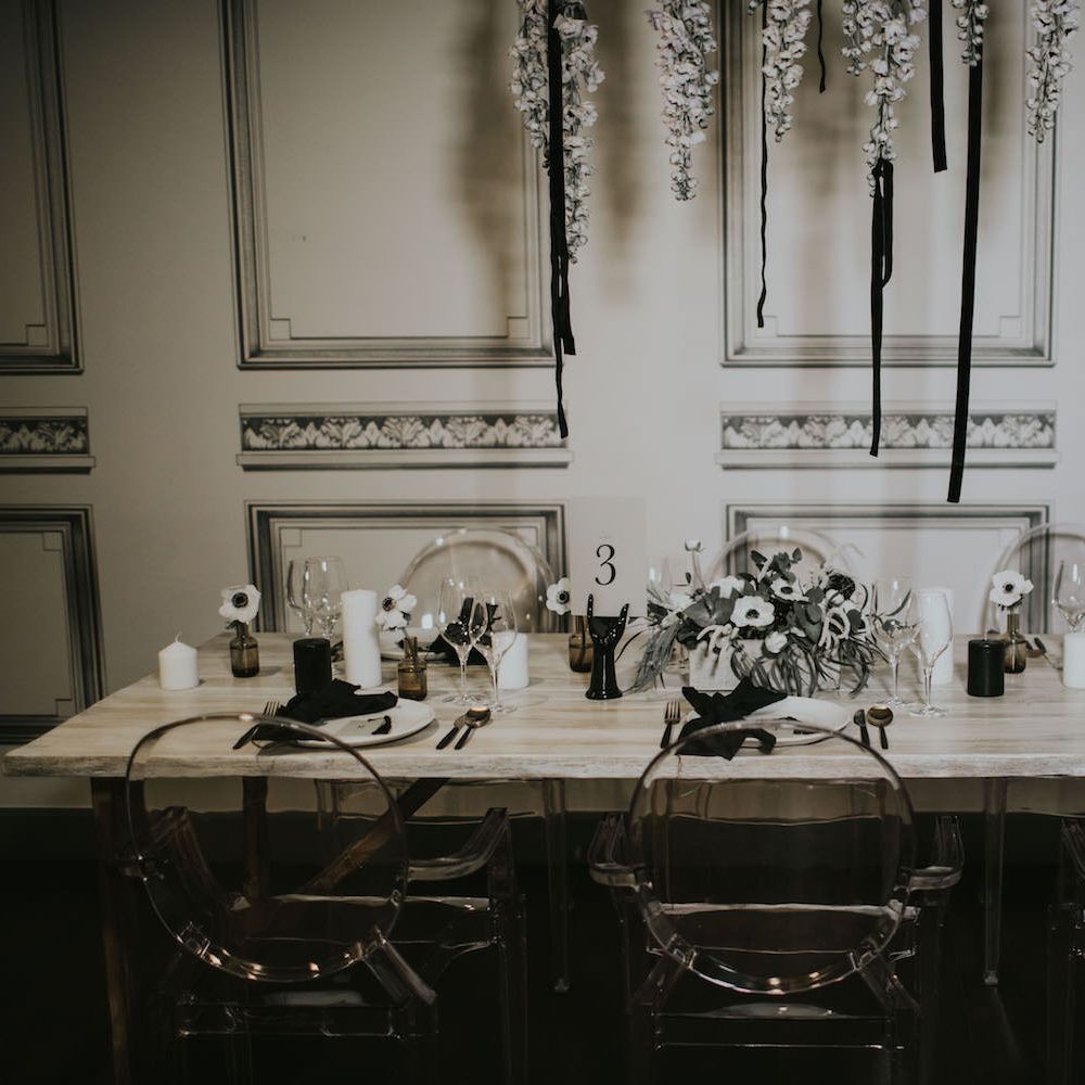 Elegant Tablescape with Ghost Chairs &amp; Hanging Anemone Floral Arrangement | Minimalist Monochrome Inspiration with Anemone's &amp; White Genista Flowers styled by The Bijou Bride | Igor Demba Photography | Gione da Silva  Film