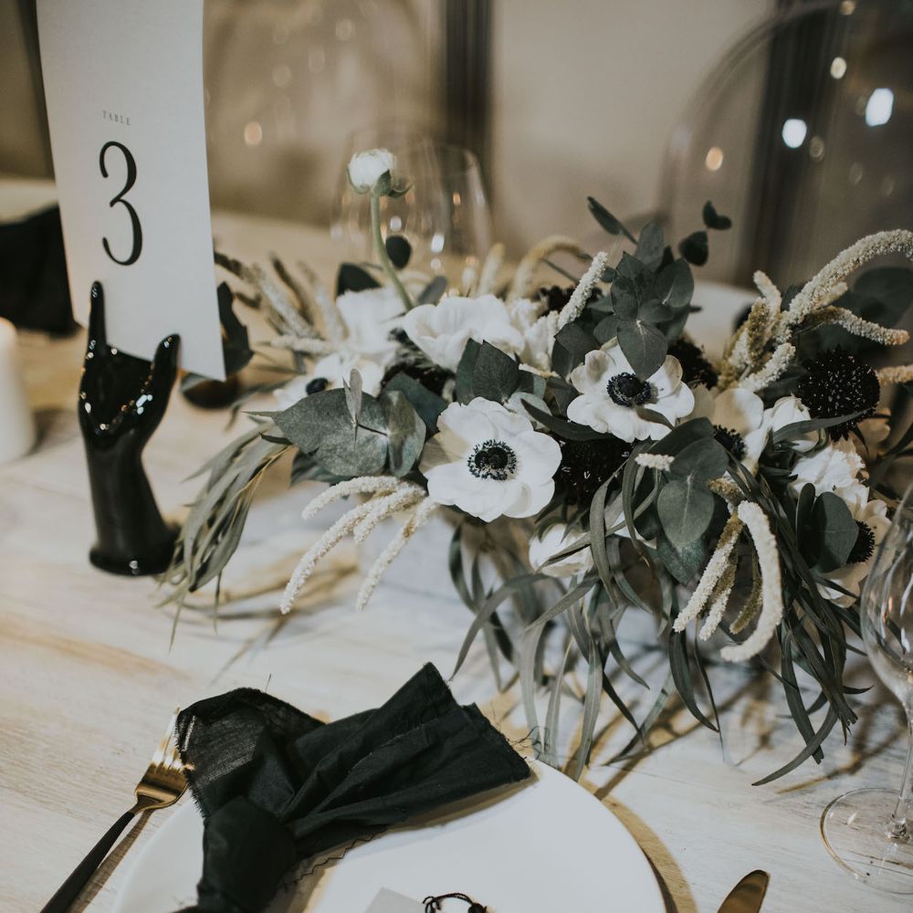 Gold Cutlery &amp; Tassel Name Place Card | Elegant Tablescape with Ghost Chairs &amp; Hanging Anemone Floral Arrangement | Minimalist Monochrome Inspiration with Anemone's &amp; White Genista Flowers styled by The Bijou Bride | Igor Demba Photography | Gione da Silva  Film