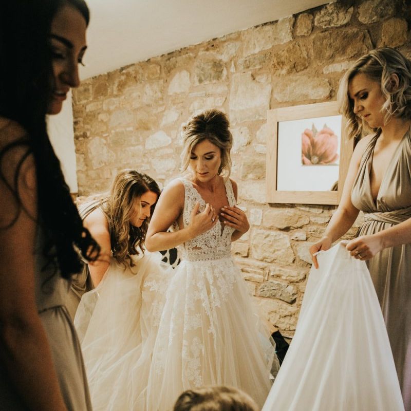 Bride puts on Enzoani wedding dress