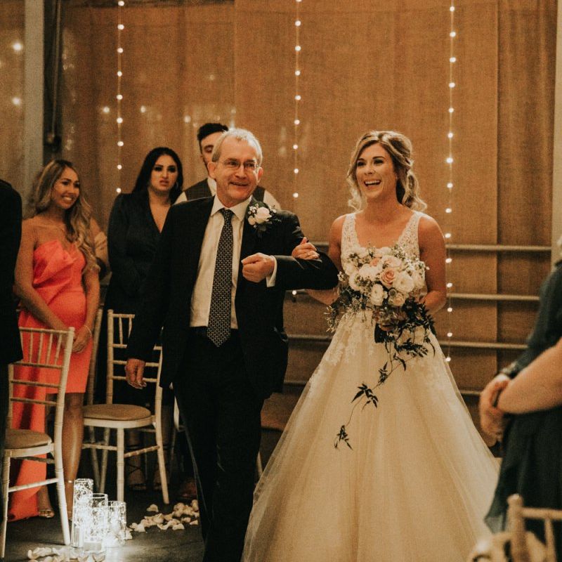 Bride walks down the aisle in Enzoani wedding dress
