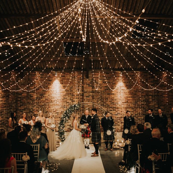 Beautiful wedding ceremony decor with fairy light canopy