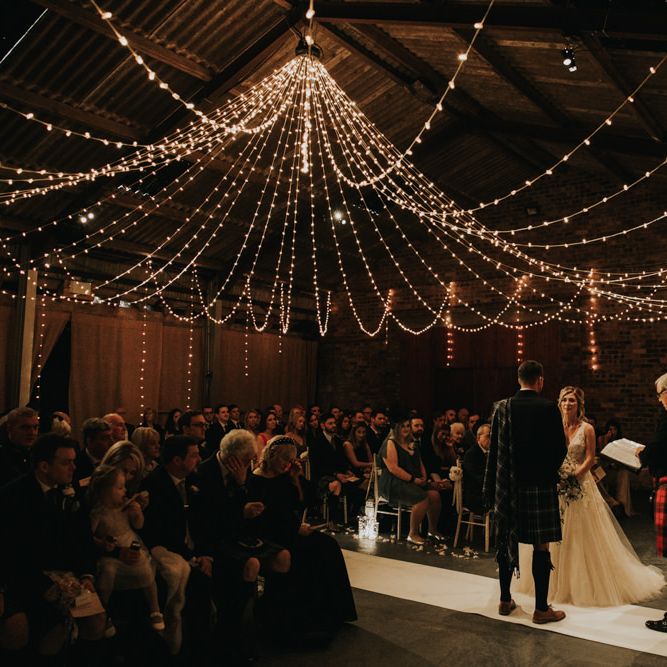 Kinkell Byre wedding ceremony with fairy light canopy and candles