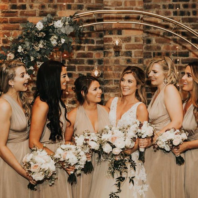 Bride in Enzoani dress with bridal party in nude bridesmaid dresses