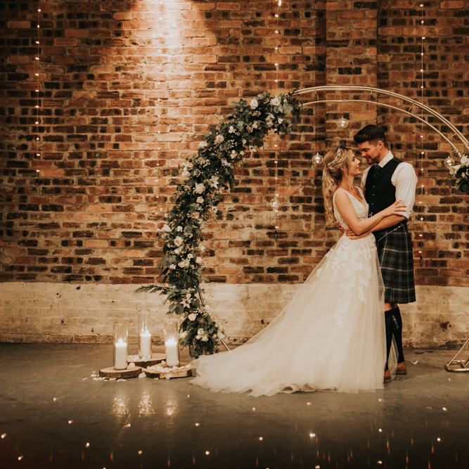 Beautiful flower arch with candles at Kinkell Byre wedding