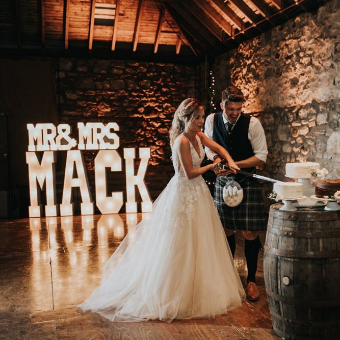 Bride and groom cut the wedding cake