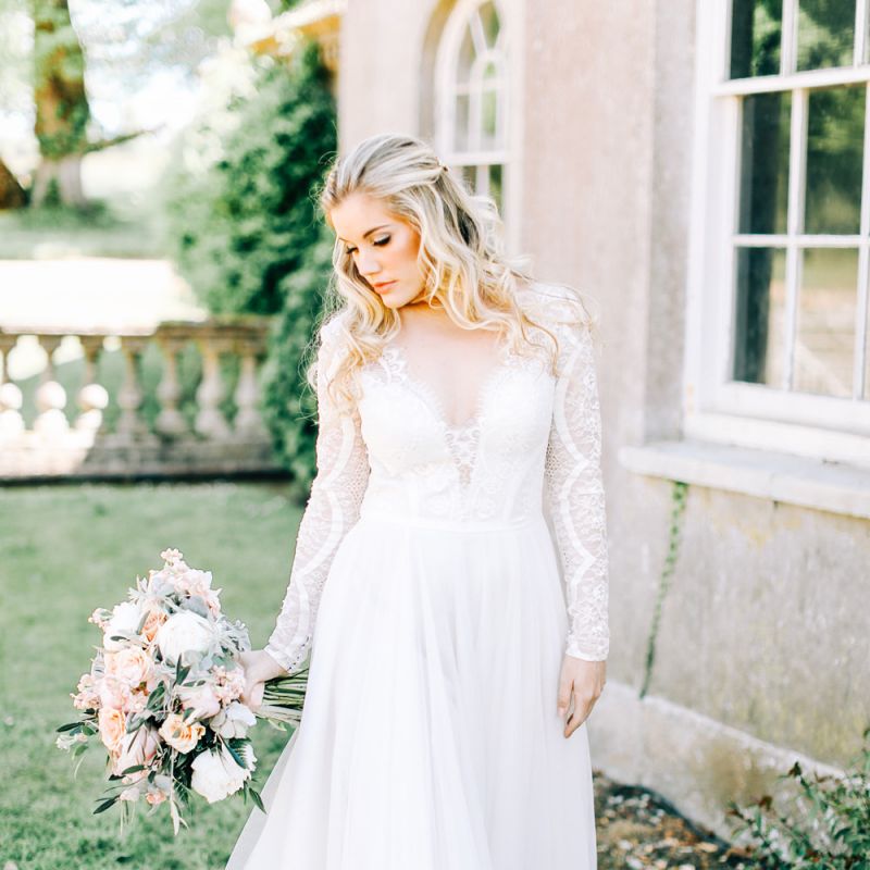 Bride in Romantic Lace Long Sleeve Wedding Dress Holding Peach &amp; Cream Bridal Bouquet