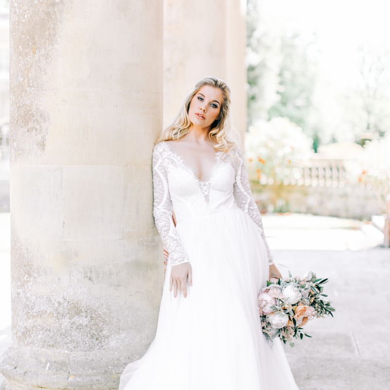 Bride in Romantic Lace Long Sleeve Wedding Dress Holding Peach &amp; White Wedding Bouquet