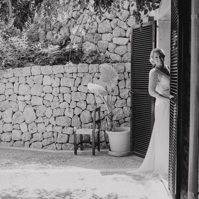 Bride Peeking Out the Venue in Lace Rembo Styling Wedding Dress