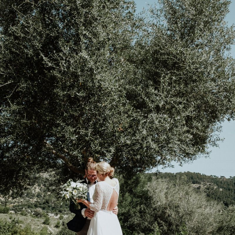Bride and Groom Sharing their First Look with Bride in a Lace Back Rembo Styling Wedding Dress