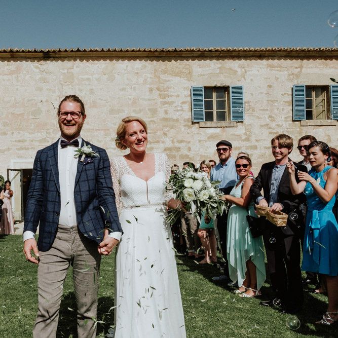 Confetti Moment with Bride in Rembo Styling Wedding Dress  and Groom  in Chino's and Checked Blazer