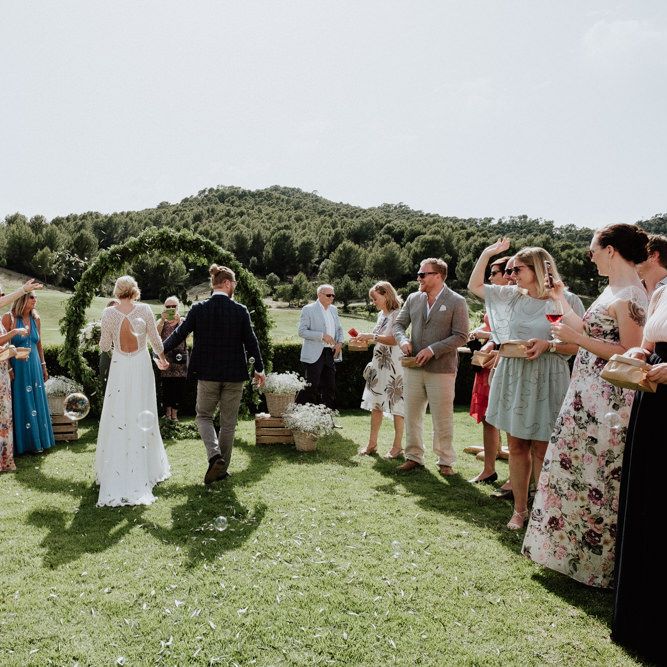 Confetti Moment with Bride in Rembo Styling Wedding Dress  and Groom  in Chino's and Checked Blazer