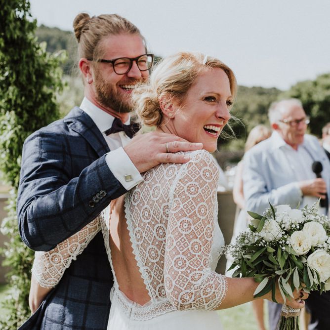 Bride in Rembo Styling Wedding Dress  and Groom  in Chino's and Checked Blazer Laughing