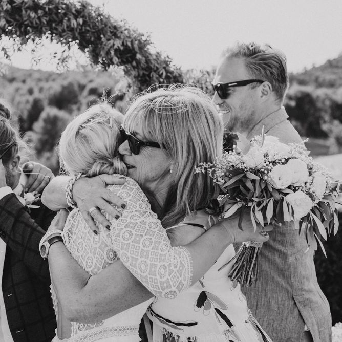 Bride and Grooms Hugging Their Wedding Guests