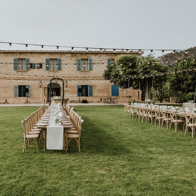 Outdoor Wedding Reception on Lawn of Destination wedding Venue with Festoon Lights