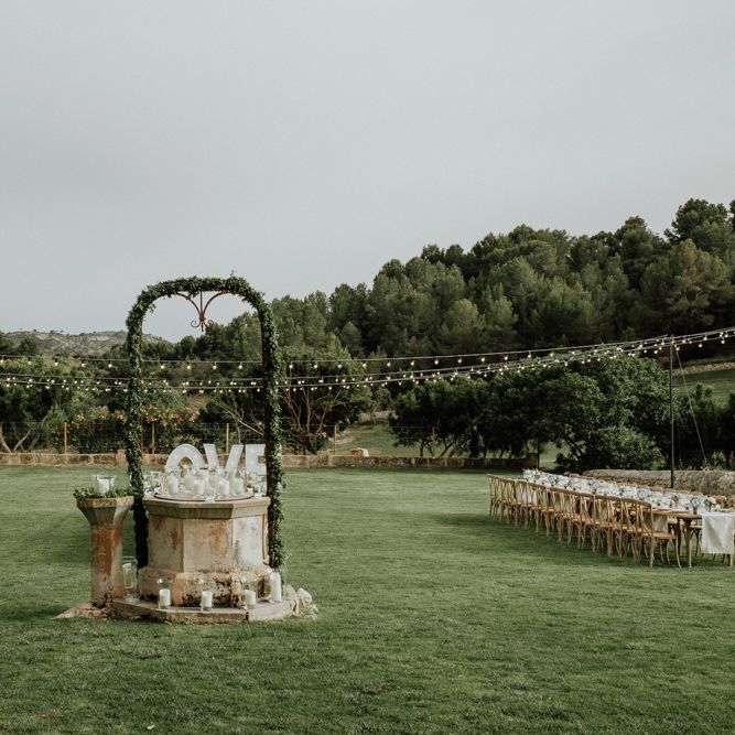 Sun Dial Wedding Feature with Foliage Arch and Candles