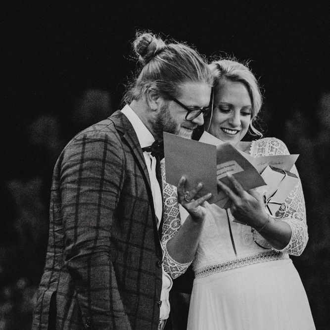Bride and Groom Reading Wedding Cards During The Reception