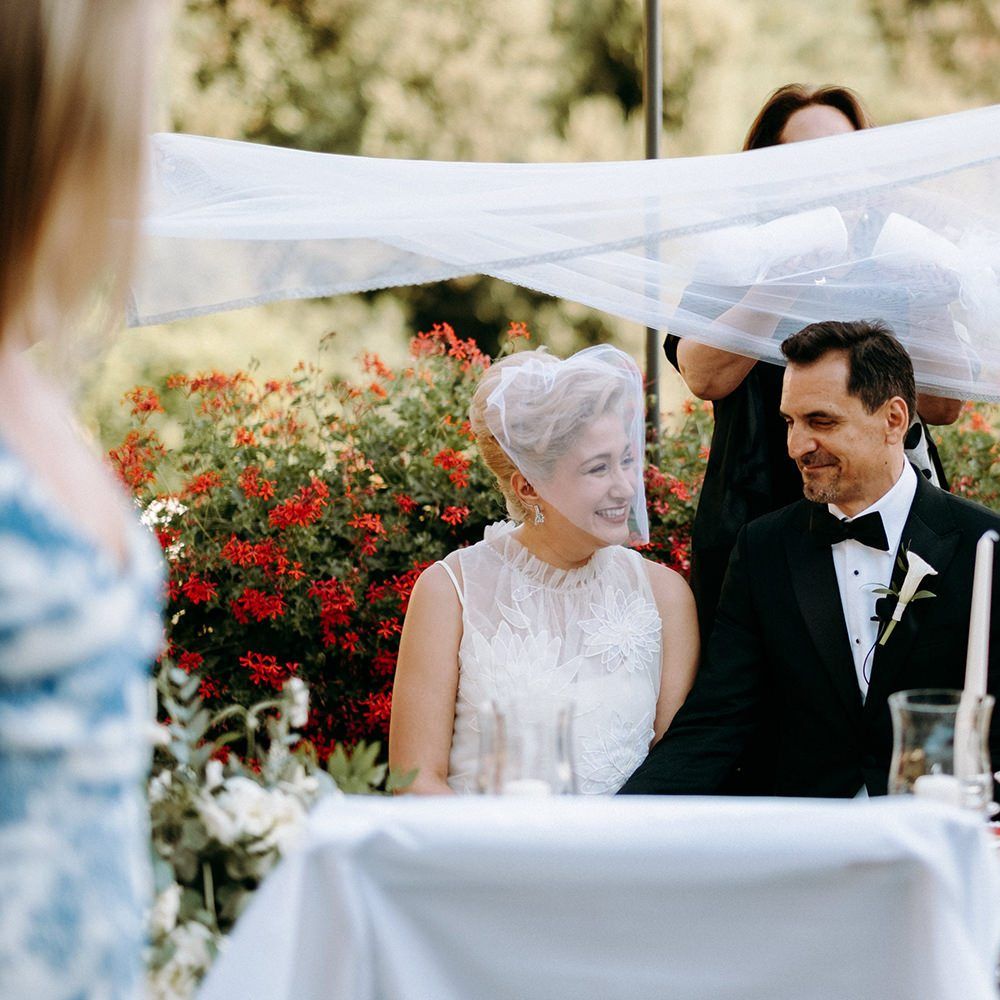 Bride in 3D flower wedding dress with groom during Persian wedding ceremony