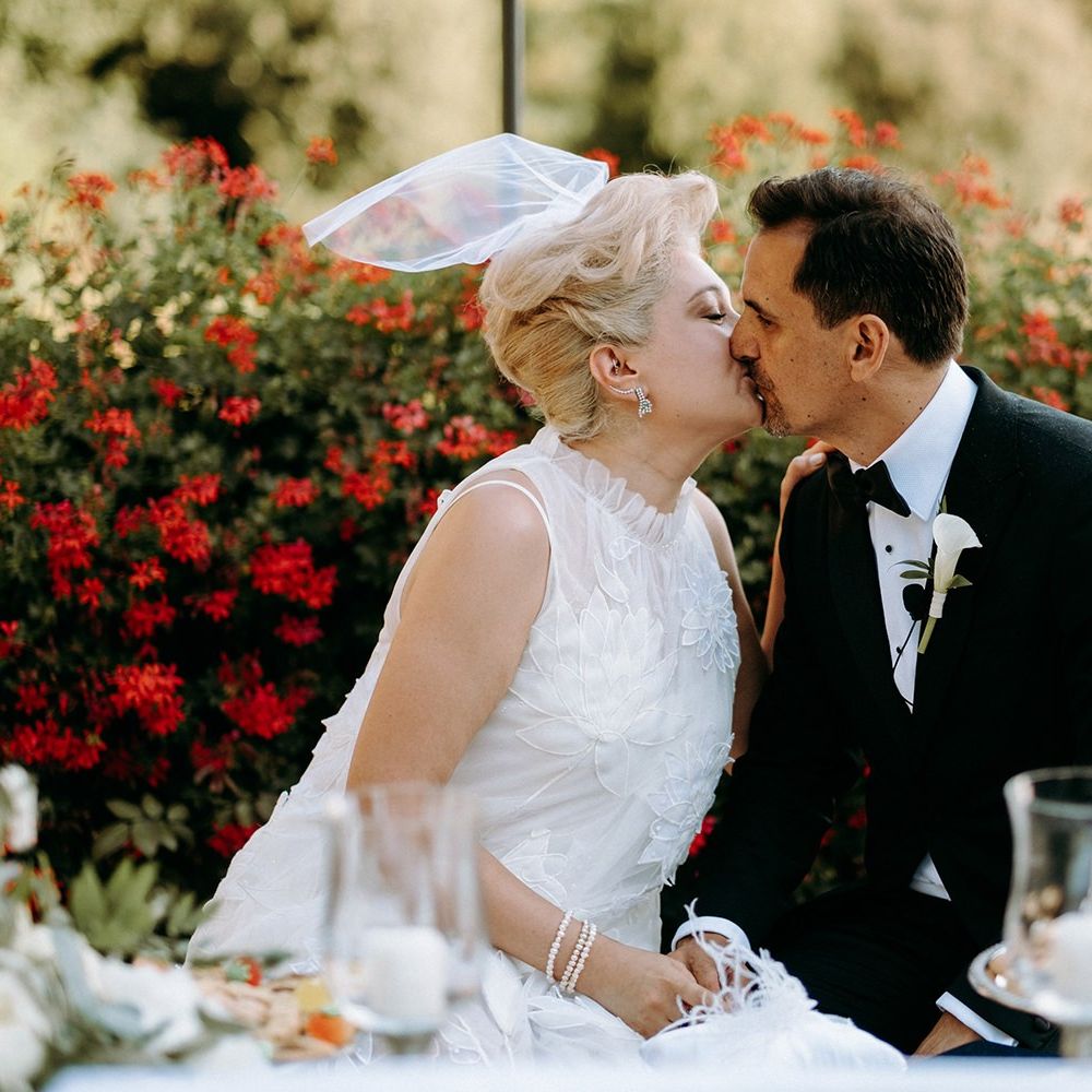 Bride wearing 3D flower wedding dress with small veil