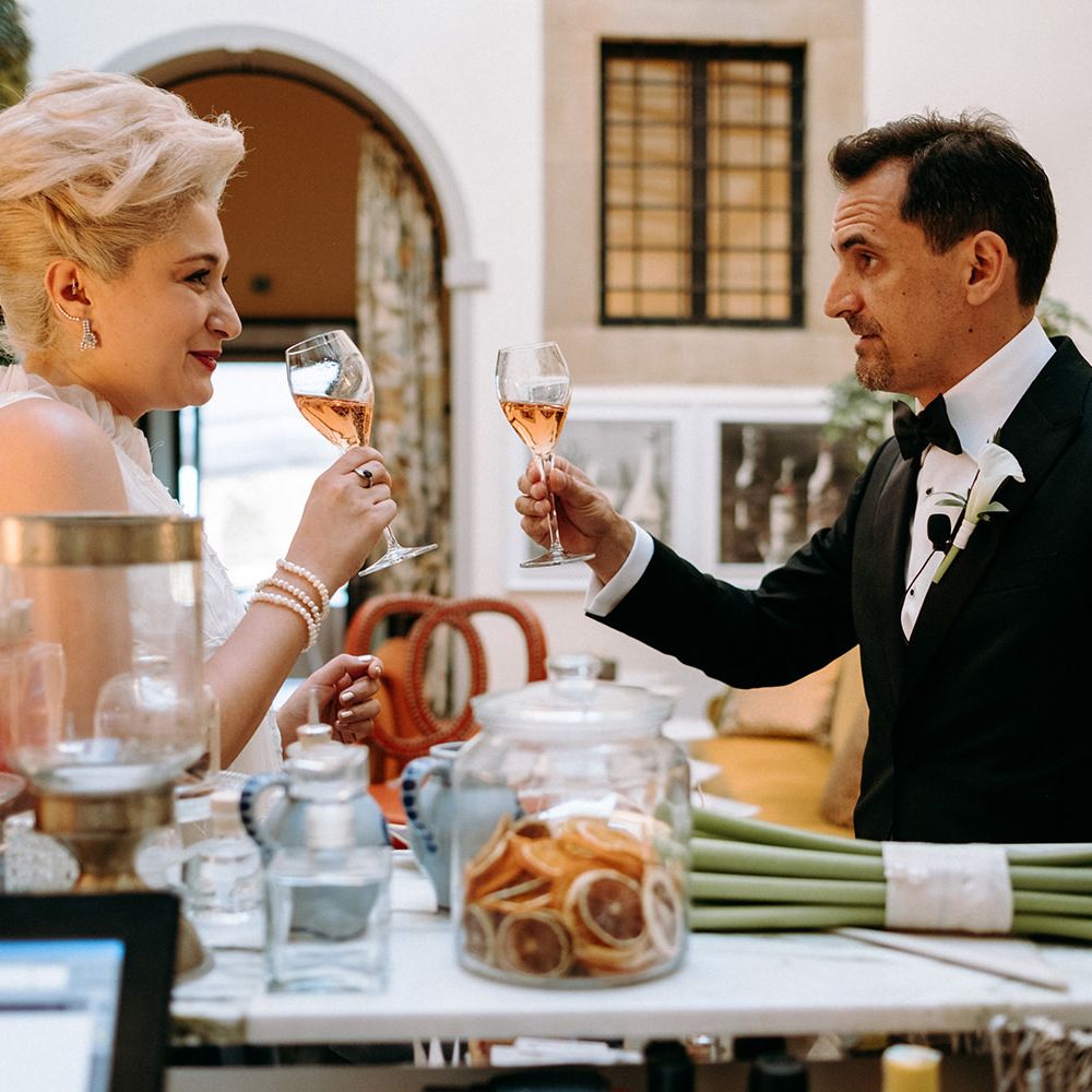 Bride in 3D flower wedding dress enjoys drink with new husband