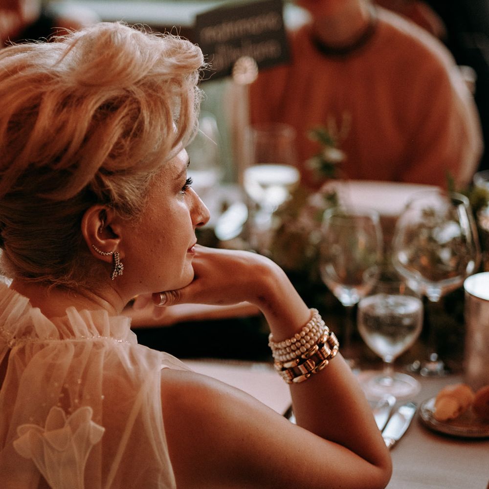 Bride in high neck 3D flower wedding dress watches short films made by new husband film maker