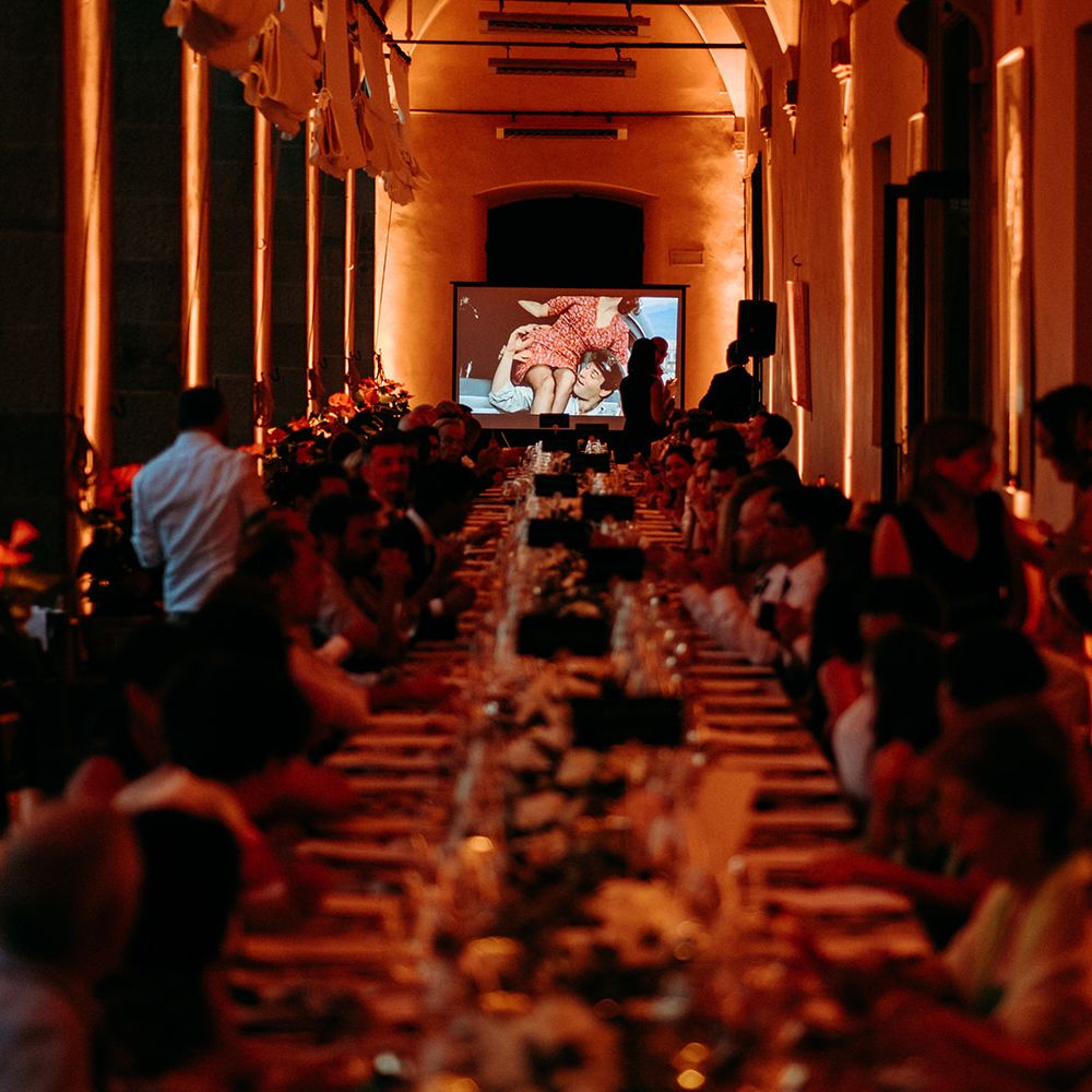 Wedding party  watches short films made by groom who is a film maker