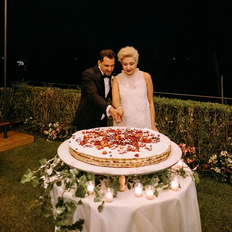 Bride and groom cut the Italian wedding cake