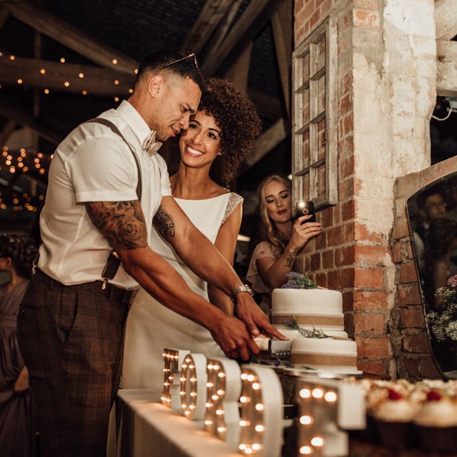 Cutting The Cake // Caribbean Influenced Wedding Kingsthorpe Lodge Barn With Steel Band And Bride In Maggie Sottero Images From Ania Ames Photography