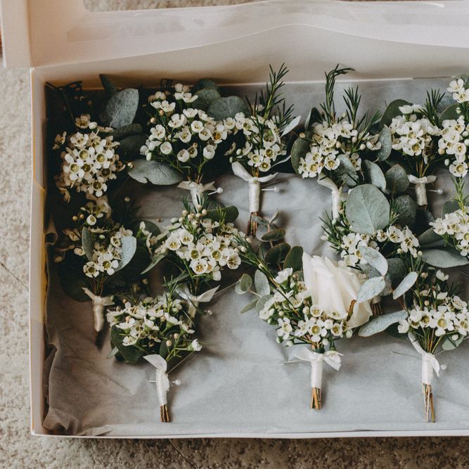 White floral buttonholes at Farbridge wedding venue