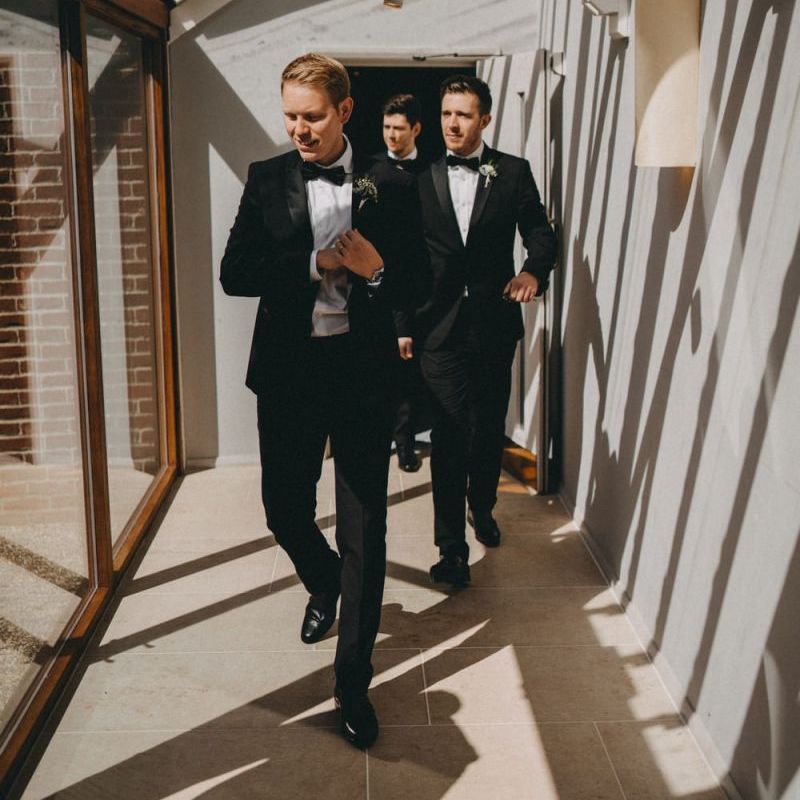 Groom and groomsmen in classic black tuxedos