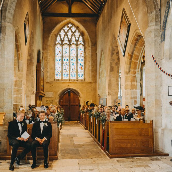 Groom waits for bride at church ceremony