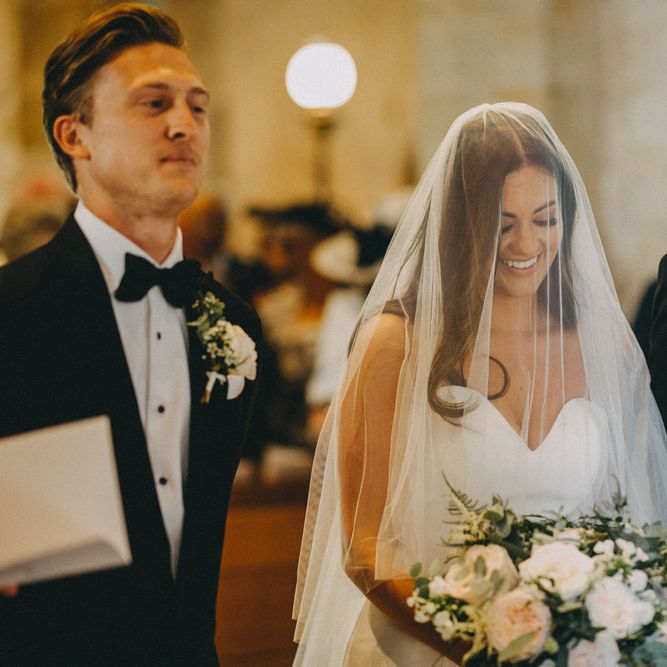 Bride greets groom at altar with veil over face