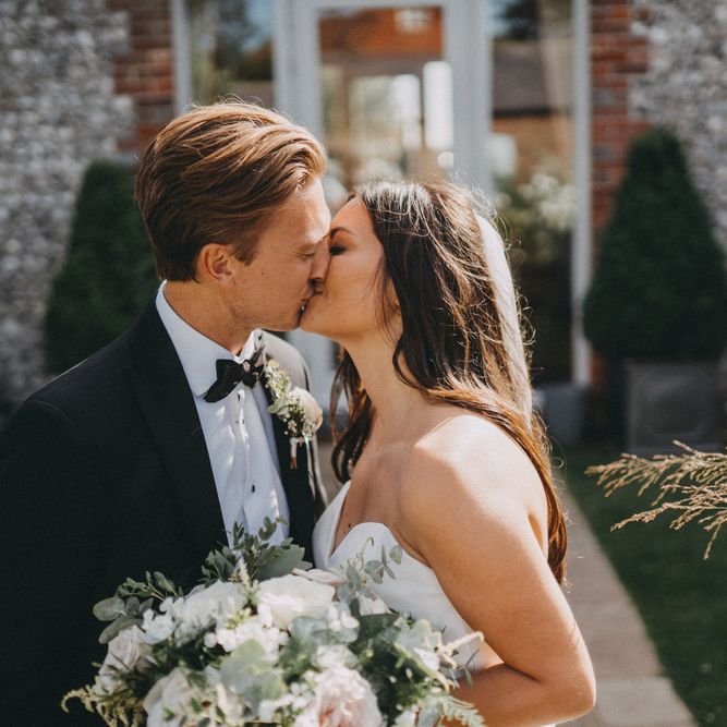 Bride and groom kiss at Farbridge wedding venue