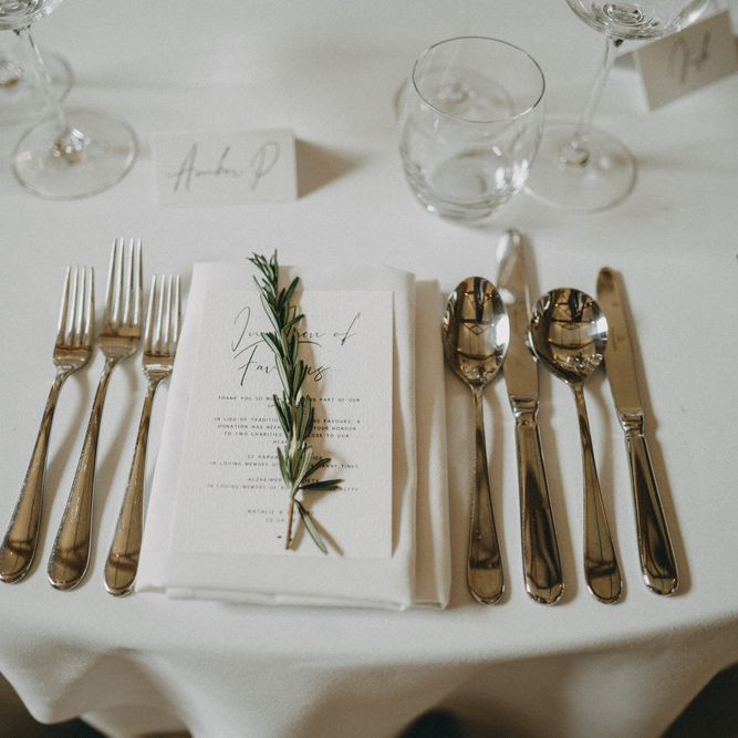 Wedding table place setting with herb decor