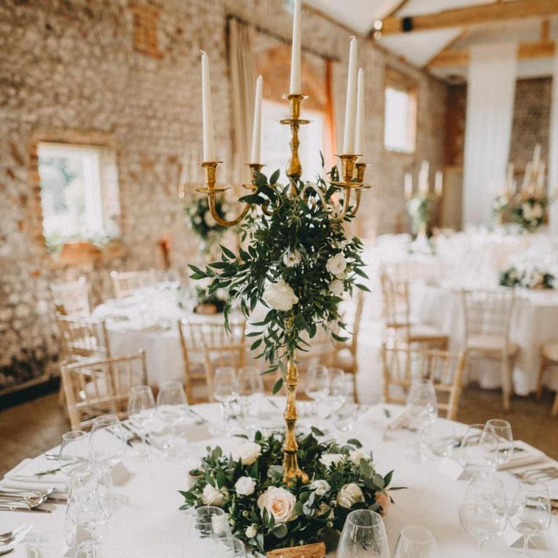 Tall floral wedding centrepiece with candelabra