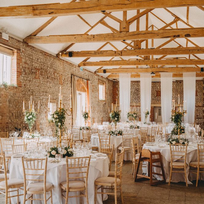 Farbridge wedding venue with tall centrepieces on table of rustic barn