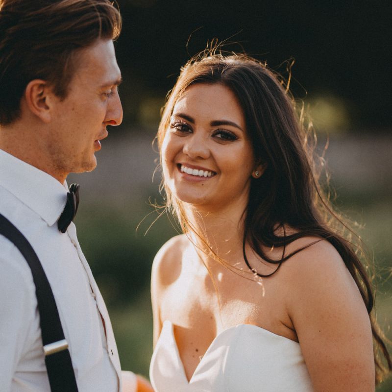 Bride in strapless fishtail wedding dress with groom in tuxedo