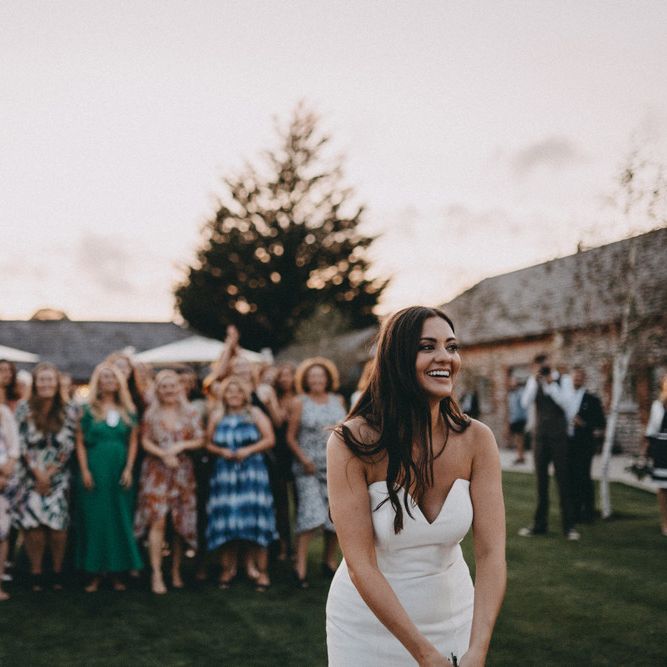 Bride gets ready to throw her bouquet to guests