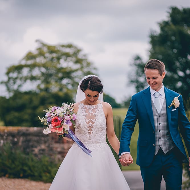 Bride in Beaded Halterneck Gown with Tulle Skirt and Spaghetti Straps by Maggie Sottero | Groom in Royal Blue Suit from Suit Supply and Tan Brogues from Barker | Pastel Wedding Bouquet with Peonies | Halterneck Maggie Sottero Dress and Garden Games at Gate Street Barn | Story + Colour Photography