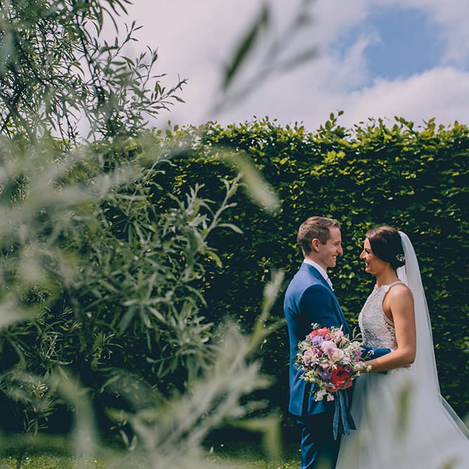Bride in Beaded Halterneck Gown with Tulle Skirt and Spaghetti Straps by Maggie Sottero | Groom in Royal Blue Suit from Suit Supply and Tan Brogues from Barker | Pastel Wedding Bouquet with Peonies | Halterneck Maggie Sottero Dress and Garden Games at Gate Street Barn | Story + Colour Photography