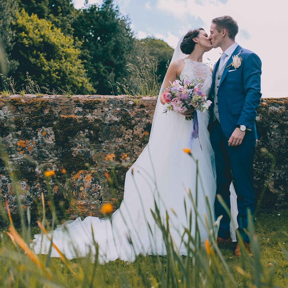 Bride in Beaded Halterneck Gown with Tulle Skirt and Spaghetti Straps by Maggie Sottero | Groom in Royal Blue Suit from Suit Supply and Tan Brogues from Barker | Pastel Wedding Bouquet with Peonies | Halterneck Maggie Sottero Dress and Garden Games at Gate Street Barn | Story + Colour Photography