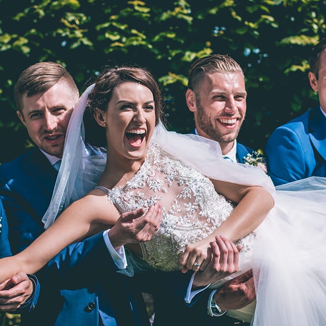 Bride in Beaded Halterneck Gown with Tulle Skirt and Spaghetti Straps by Maggie Sottero | Full Length Veil | Groomsmen in Navy Blue Suits with Pastel Blue Ties | Halterneck Maggie Sottero Dress and Garden Games at Gate Street Barn | Story + Colour Photography