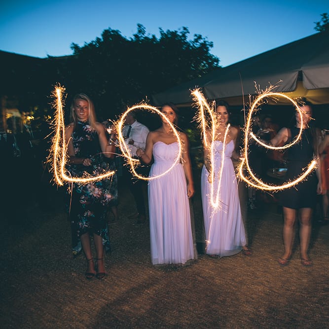 Sparklers | Pastel Blue Bridesmaids Dresses from ASOS | Halterneck Maggie Sottero Dress and Garden Games at Gate Street Barn | Story + Colour Photography
