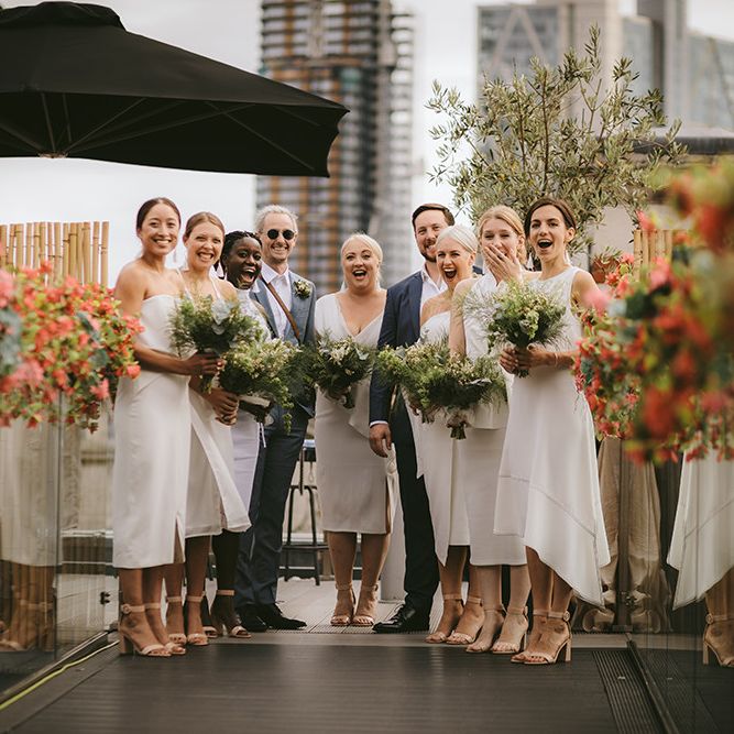 Bridal Party First Look | Bridesmaids in Mismatched White Dresses | Bridesmen in Blue Suits | Homemade Bouquets of White Flowers, Ferns and Foliage | Bike Shed Motorcycle Club Wedding for ELLE Digital Editor | Nigel John Photography