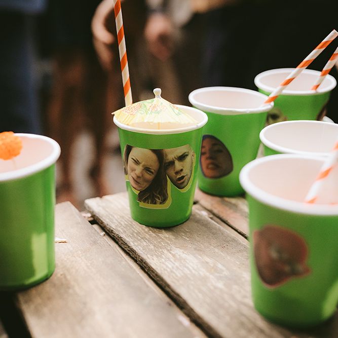 Tequila Cocktails Served in Green Cups with Photos of Bride and Groom on Side | Bike Shed Motorcycle Club Wedding for ELLE Digital Editor | Nigel John Photography