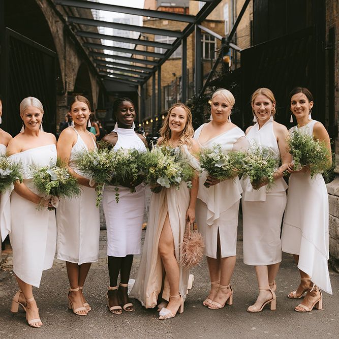 Bride in Bespoke Wedding Gown with Blush Underskirt and One Off Shoulder Strap | Nude Topshop Shoes with Pom Pom | Bridesmaids in Mismatched White Dresses | Homemade Bouquets of White Flowers, Ferns and Foliage | Bike Shed Motorcycle Club Wedding for ELLE Digital Editor | Nigel John Photography