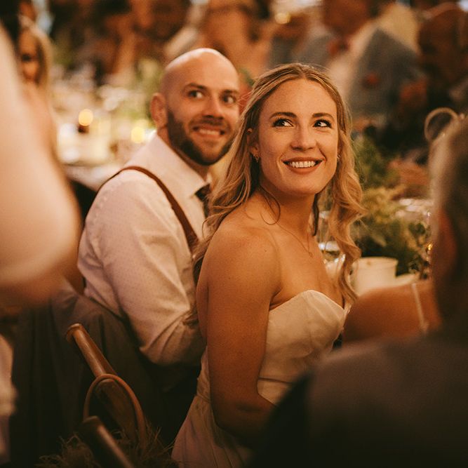 Wedding Reception Speeches | Bride in Bespoke Wedding Gown with Blush Underskirt and One Off Shoulder Strap | Half Up Half Down Bridal Hair | Groom in Grey Puppy Tooth Check Two-Piece Paul Smith Suit with Amber Tie Pin, Pocket Square and Braces | Bike Shed Motorcycle Club Wedding for ELLE Digital Editor | Nigel John Photography