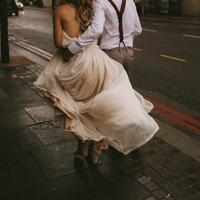 Bride in Bespoke Wedding Gown with Blush Underskirt and One Off Shoulder Strap | Half Up Half Down Bridal Hair | Nude Topshop Shoes with Pom Pom | Groom in Grey Puppy Tooth Check Two-Piece Paul Smith Suit with Amber Tie Pin, Pocket Square and Braces | Bike Shed Motorcycle Club Wedding for ELLE Digital Editor | Nigel John Photography